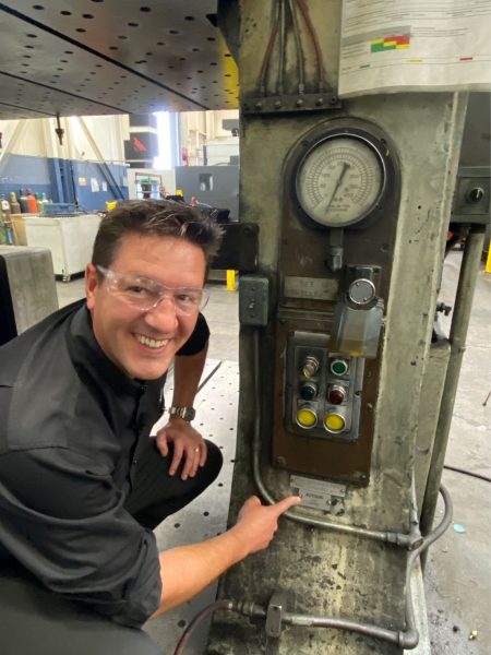 Brian Bendig loves machinery and equipment. He is pictured her barely containing a big smile while pointing to a new machine he recently acquired.