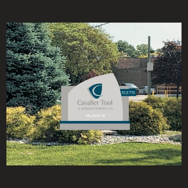 This is a picture of the front lawn at Cavalier Plant 2. There is a graphic overlay of the new sign that will be replace the old MSI sign as Cavalier Tool Expands.